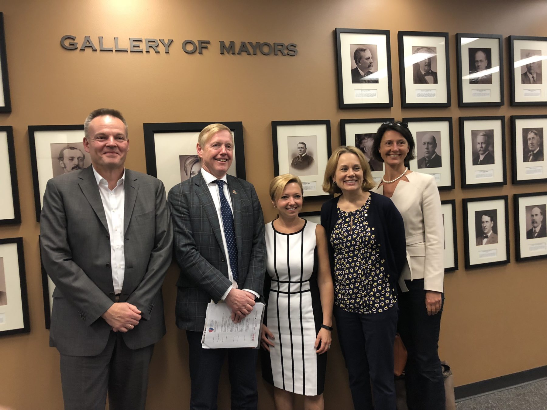 (From Left) Markus Lux, Amb. Aas, Mayor Bliss, Julie Smith, and Kadri Liik are all smiles in front of Grand Rapids City Hall’s Gallery of Mayors