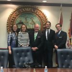 The Honorable Michèle Flournoy, Julianne Smith, the Rt. Hon David Miliband, and Amb Peter Wittig pose for a picture with the Mayor of Tampa, Bob Buckhorn